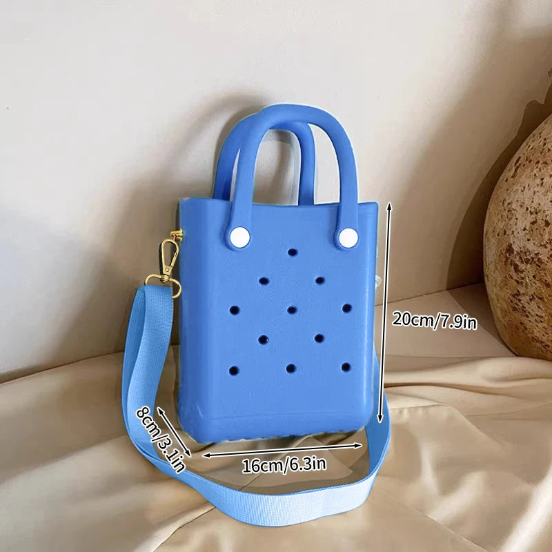 Blue handbag with measurements on a beige surface