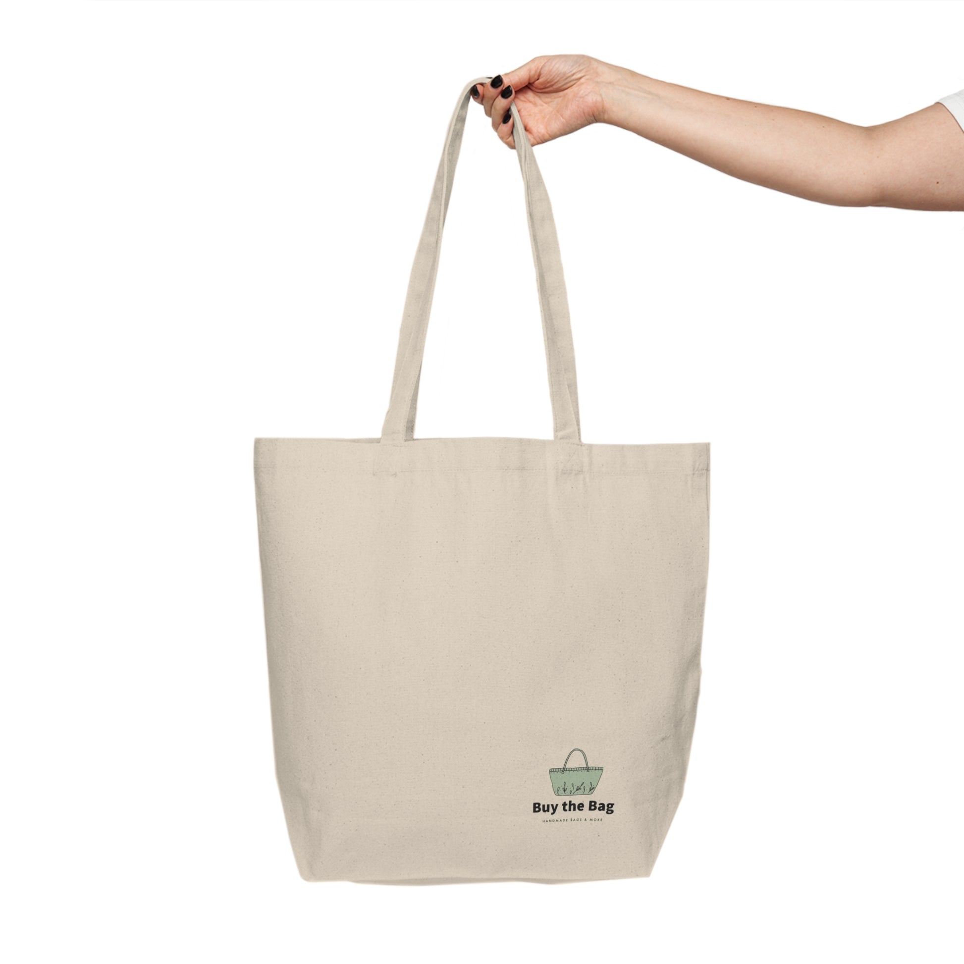 A natural canvas tote bag with long handles The bag features a small graphic near the bottom right with a green shopping bag icon and the text 'Buy the Bag'.
