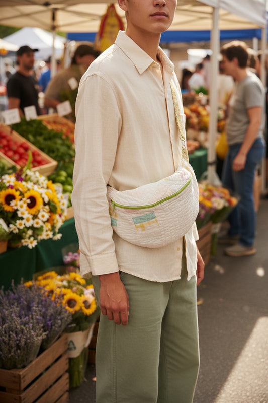 White bag with a floral strap on a wooden surface