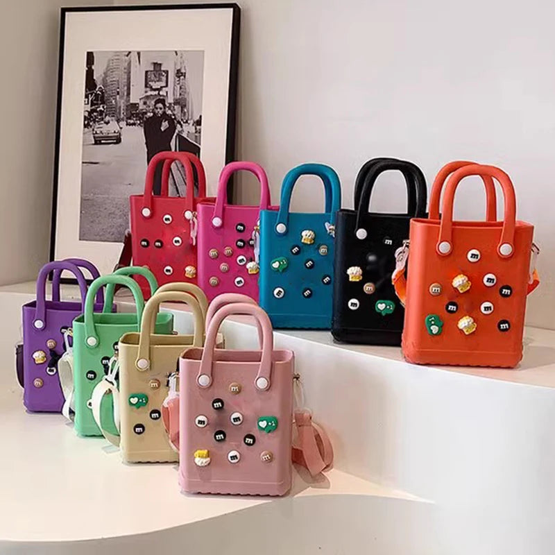 Colorful mini handbags with decorative elements on a white surface.