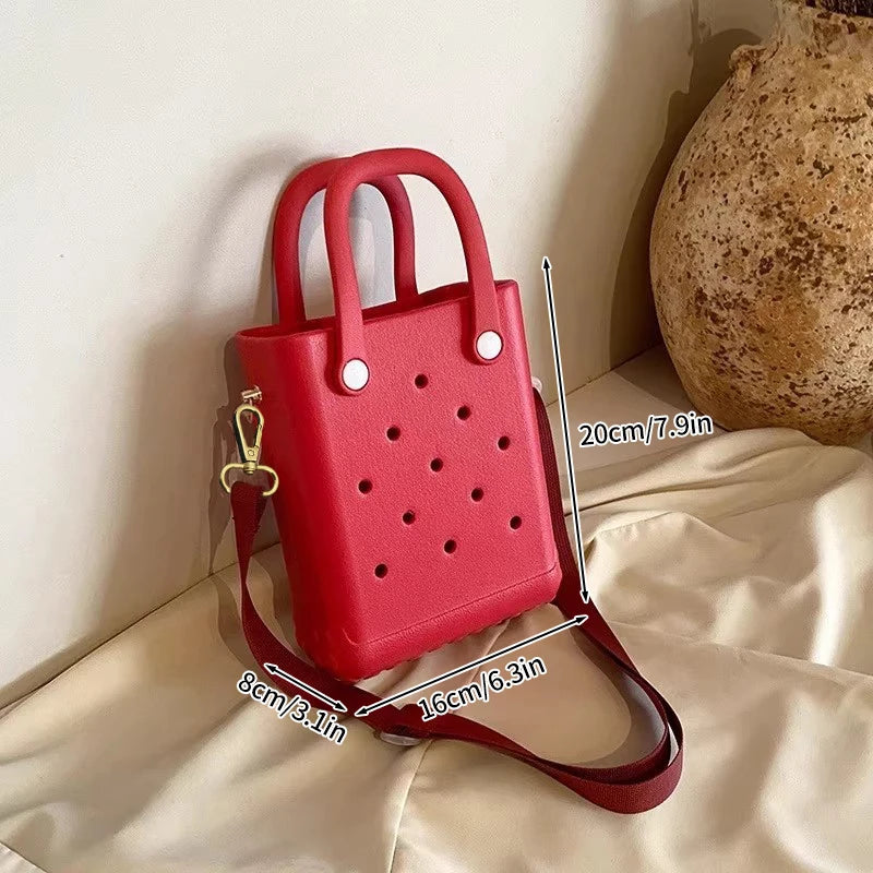 Red handbag with measurements on a light background