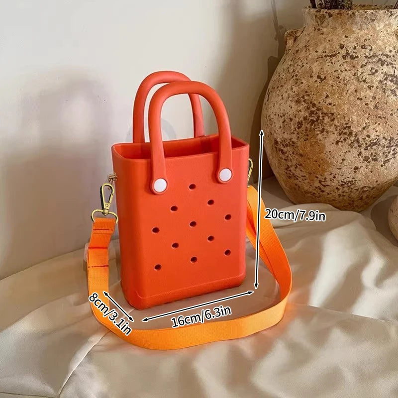 Orange handbag with measurements on a light background