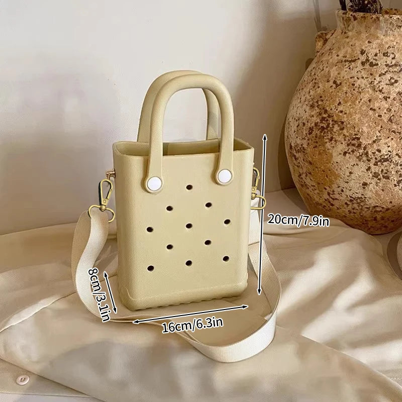 Beige handbag with measurements on a neutral background